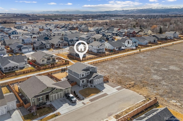 birds eye view of property with a mountain view and a residential view