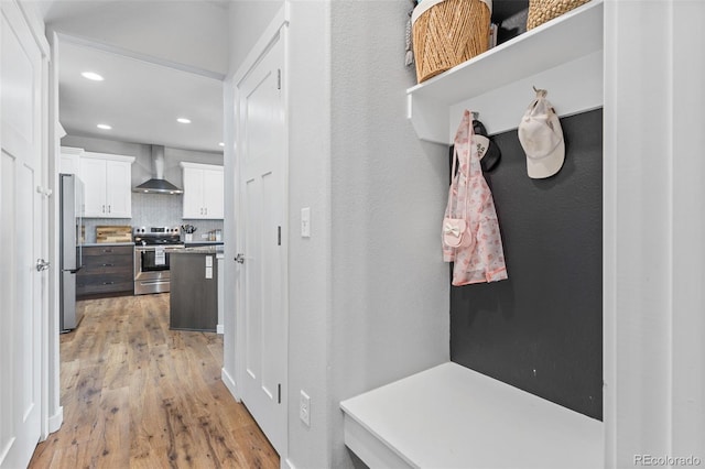 mudroom featuring light wood finished floors and recessed lighting