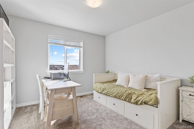 bedroom with light carpet and baseboards