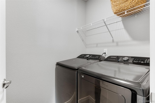 laundry room featuring laundry area and washing machine and clothes dryer