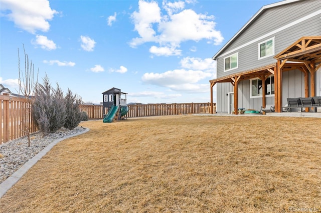 view of yard with a playground and a fenced backyard