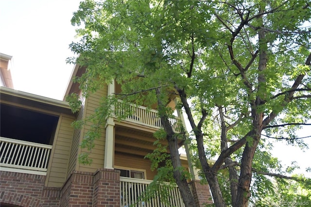 1631 W Canal Cir Unit 832, Littleton, CO 80120 - view of home's exterior with a balcony and brick siding