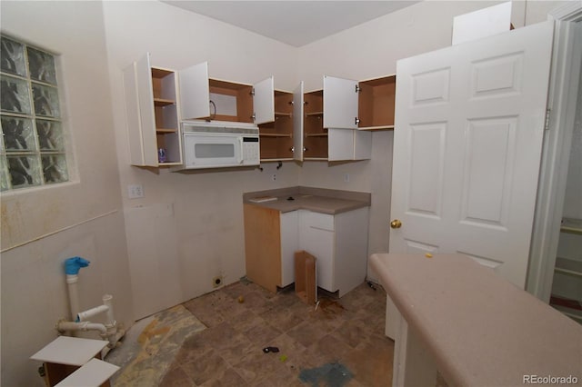 1631 W Canal Cir Unit 832, Littleton, CO 80120 - kitchen featuring white microwave and open shelves