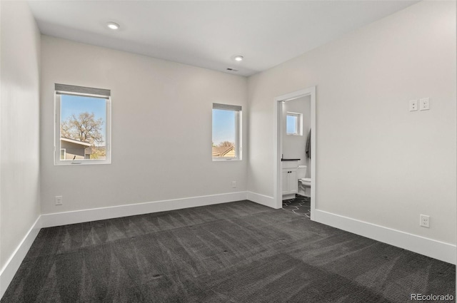 5240 N Raleigh St, Denver, CO 80212 - empty room with dark carpet, healthy amount of natural light, and baseboards