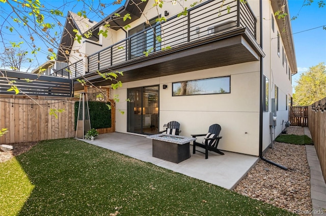 5240 N Raleigh St, Denver, CO 80212 - rear view of property featuring a balcony, a patio, an outdoor fire pit, and stucco siding