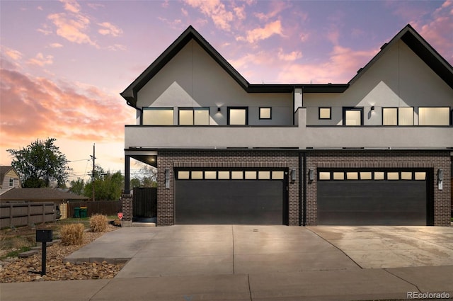 5240 N Raleigh St, Denver, CO 80212 - view of front facade featuring driveway, an attached garage, and brick siding