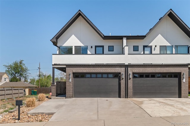 5240 N Raleigh St, Denver, CO 80212 - view of front of property with a garage, driveway, brick siding, and stucco siding
