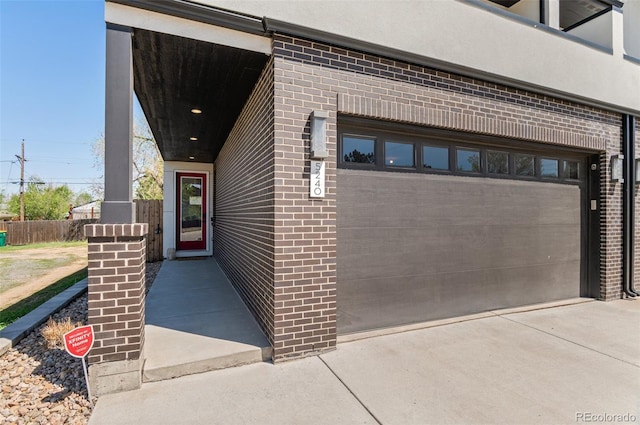 5240 N Raleigh St, Denver, CO 80212 - property entrance featuring brick siding and a garage