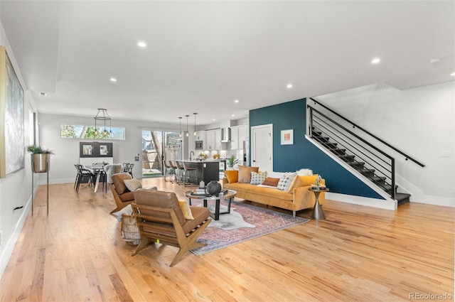 5240 N Raleigh St, Denver, CO 80212 - living room featuring stairs, light wood-type flooring, recessed lighting, and baseboards