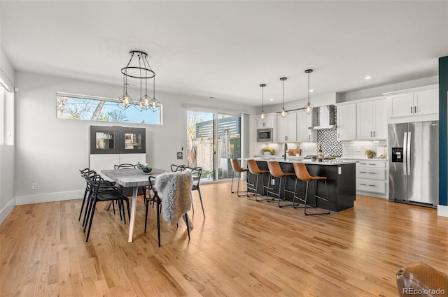 5240 N Raleigh St, Denver, CO 80212 - dining space featuring light wood-style floors, recessed lighting, baseboards, and a chandelier