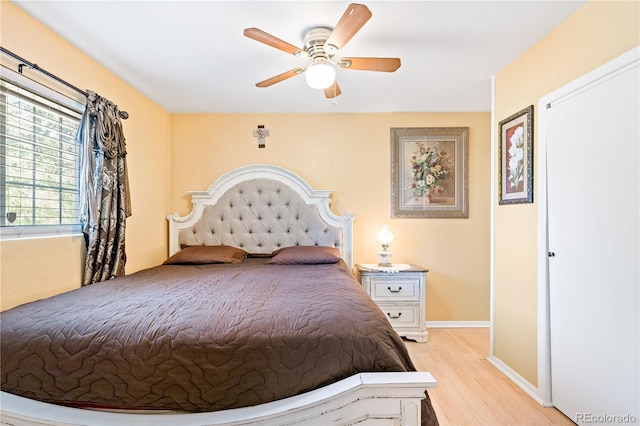 bedroom with ceiling fan and light hardwood / wood-style flooring