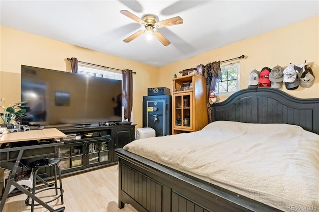 bedroom with light hardwood / wood-style floors and ceiling fan