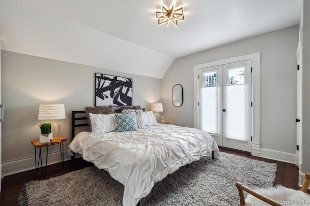 bedroom featuring lofted ceiling, access to exterior, baseboards, and dark wood-style flooring