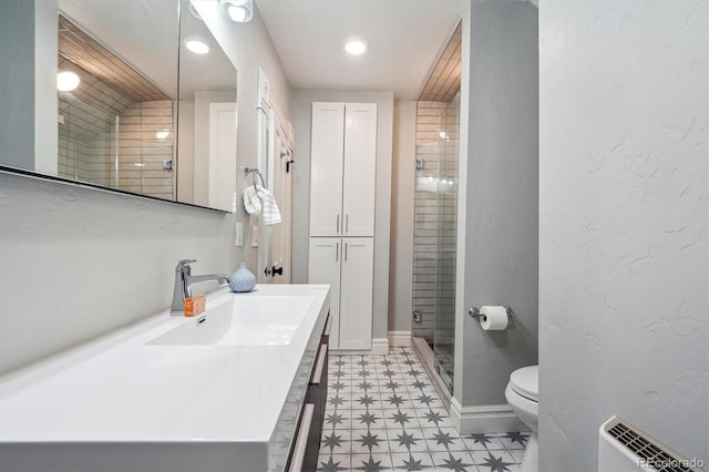 full bathroom with toilet, vanity, baseboards, a shower stall, and tile patterned floors