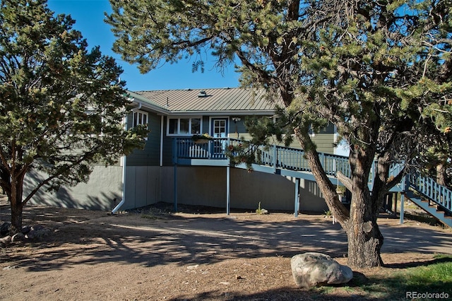 246 Baca Grant Way, Crestone, CO 81131 - back of house with stairs, metal roof, and a wooden deck
