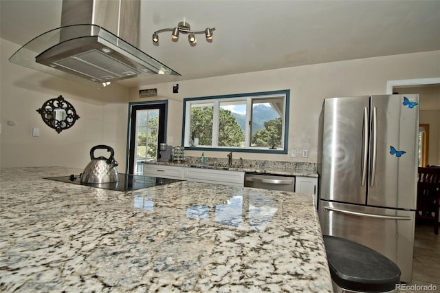 246 Baca Grant Way, Crestone, CO 81131 - kitchen featuring a sink, white cabinetry, range hood, light stone countertops, and appliances with stainless steel finishes