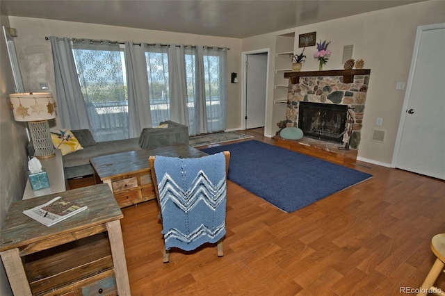 246 Baca Grant Way, Crestone, CO 81131 - living room with a fireplace, baseboards, visible vents, and wood finished floors