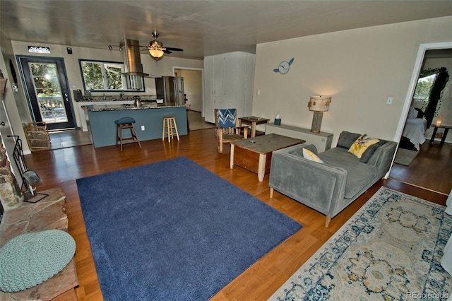 246 Baca Grant Way, Crestone, CO 81131 - living area with a ceiling fan, a healthy amount of sunlight, and wood finished floors