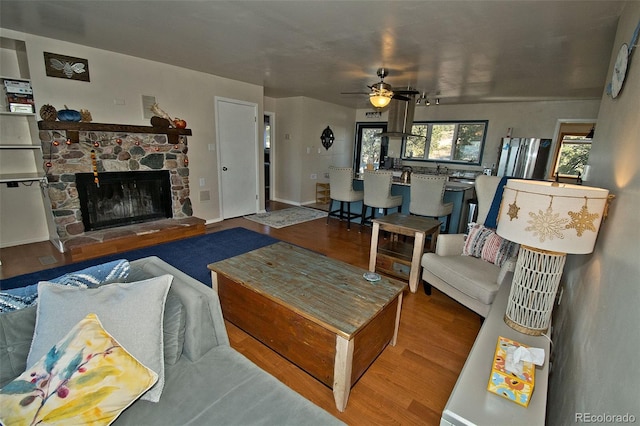 246 Baca Grant Way, Crestone, CO 81131 - living area featuring wood finished floors, a fireplace, and ceiling fan