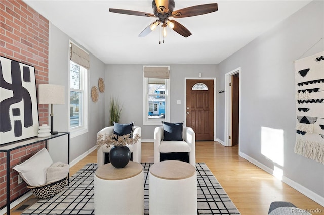 living room with ceiling fan and light hardwood / wood-style flooring