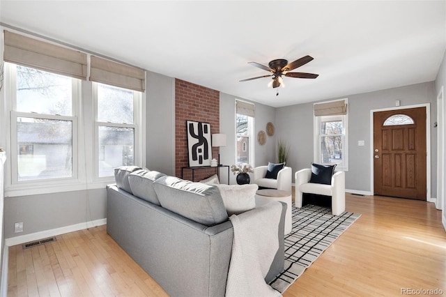 living room featuring ceiling fan and wood-type flooring