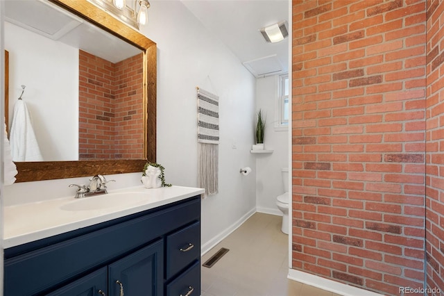 bathroom featuring toilet, tile patterned flooring, and vanity