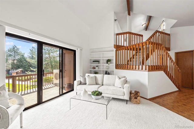 501 Manhattan Dr Unit 202, Boulder, CO 80303 - living area featuring beamed ceiling, high vaulted ceiling, stairs, and baseboards
