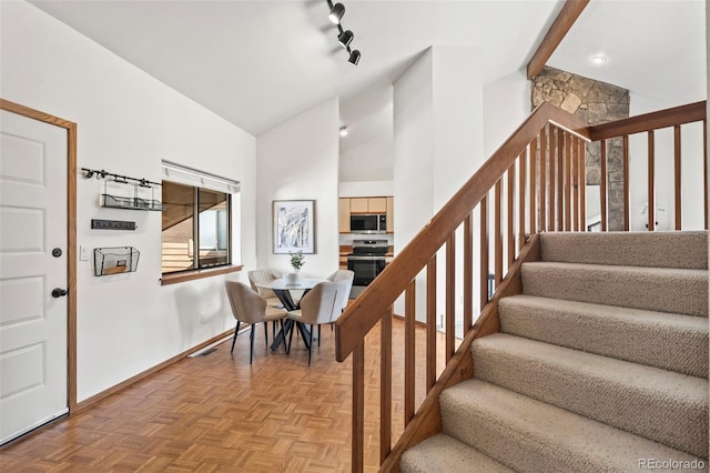501 Manhattan Dr Unit 202, Boulder, CO 80303 - staircase with baseboards and lofted ceiling