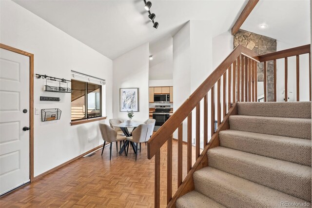 501 Manhattan Dr Unit 202, Boulder, CO 80303 - staircase with baseboards and lofted ceiling