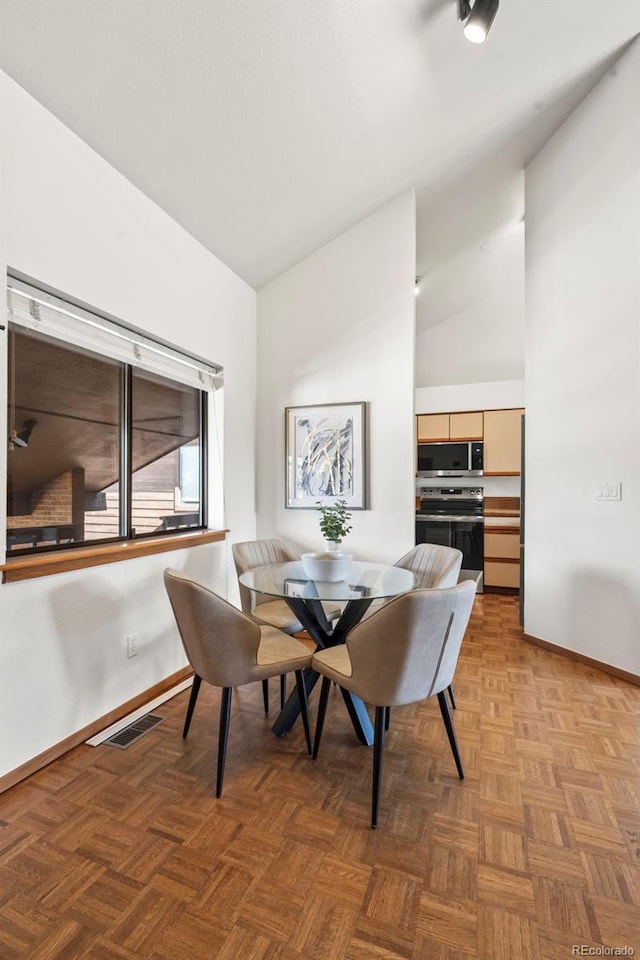501 Manhattan Dr Unit 202, Boulder, CO 80303 - dining area with baseboards and high vaulted ceiling