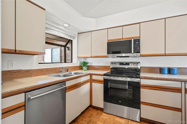 501 Manhattan Dr Unit 202, Boulder, CO 80303 - kitchen featuring stainless steel appliances, a sink, light countertops, and white cabinets