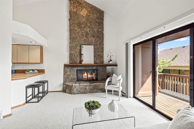 501 Manhattan Dr Unit 202, Boulder, CO 80303 - carpeted living area with high vaulted ceiling, baseboards, and a stone fireplace