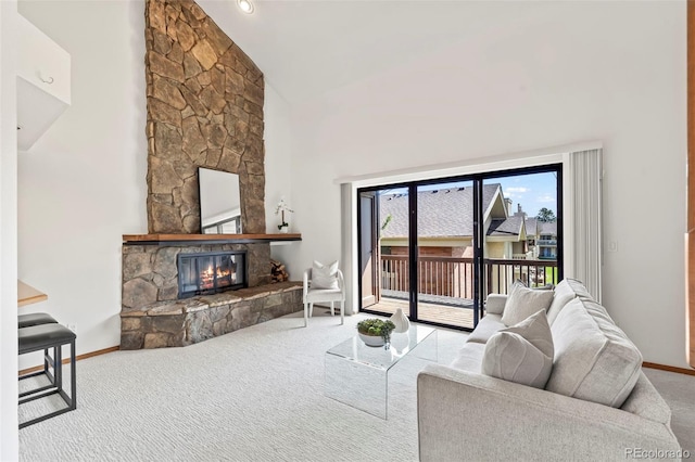 501 Manhattan Dr Unit 202, Boulder, CO 80303 - living area featuring carpet floors, a stone fireplace, baseboards, and high vaulted ceiling