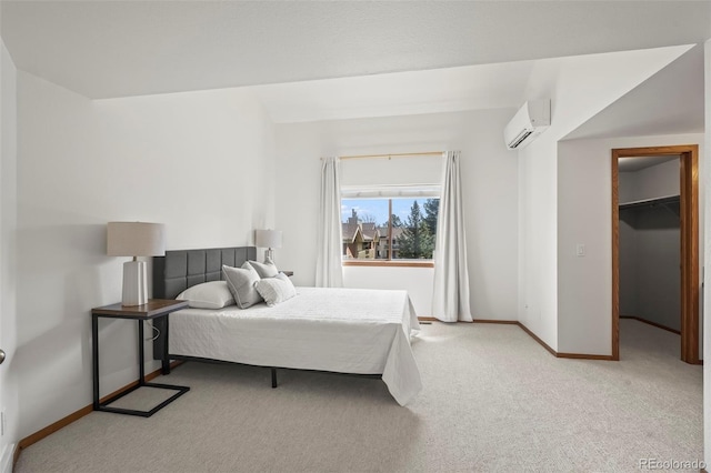 501 Manhattan Dr Unit 202, Boulder, CO 80303 - bedroom featuring a wall mounted AC, light carpet, baseboards, and a spacious closet