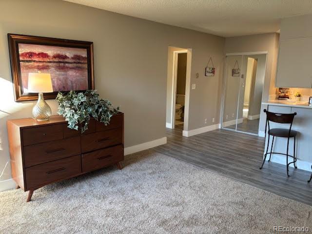 living room with carpet floors and a textured ceiling