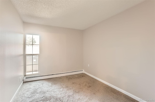 carpeted empty room featuring baseboard heating, plenty of natural light, and a textured ceiling