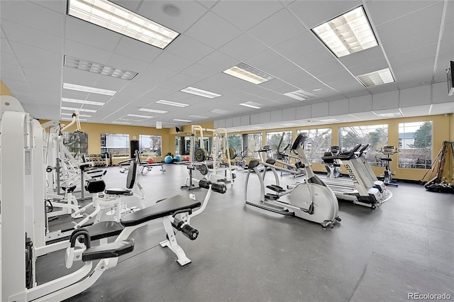 gym with a paneled ceiling