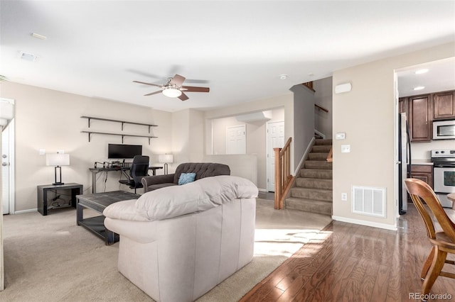 living room with ceiling fan and light wood-type flooring