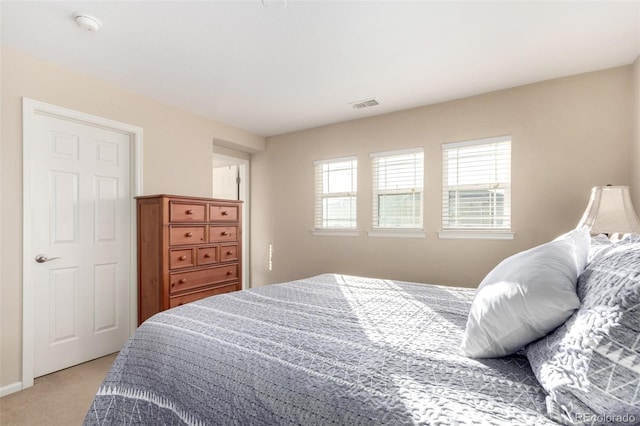 bedroom with light colored carpet