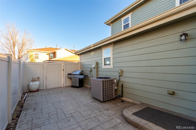 view of patio featuring area for grilling and cooling unit