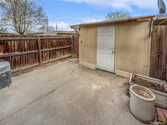 view of patio with a storage unit