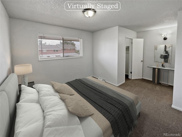 carpeted bedroom with a textured ceiling