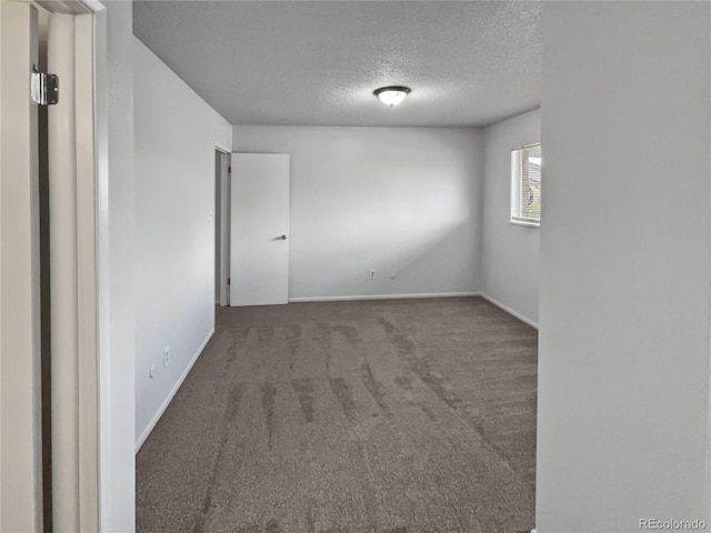 spare room with carpet floors and a textured ceiling