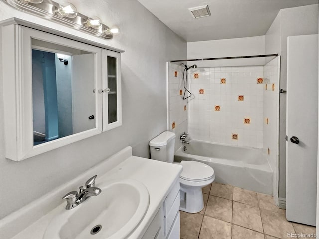 full bathroom with tiled shower / bath combo, vanity, tile floors, and toilet