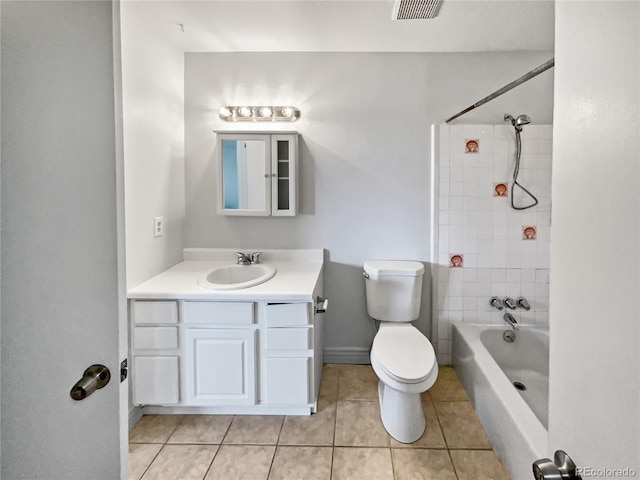 full bathroom featuring tile floors, vanity, tiled shower / bath combo, and toilet