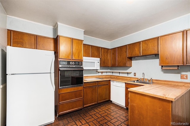 6019 Taft Ct, Arvada, CO 80004 - kitchen featuring white appliances, brown cabinets, brick patterned floors, and wallpapered walls