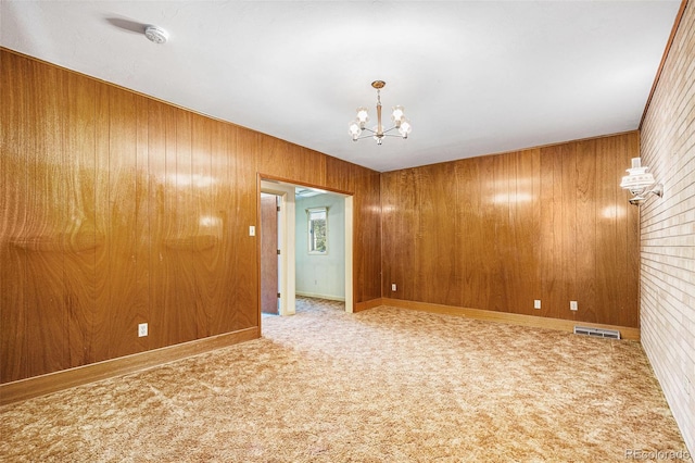 6019 Taft Ct, Arvada, CO 80004 - carpeted spare room with a chandelier, wooden walls, and a smoke detector
