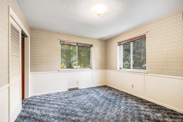 6019 Taft Ct, Arvada, CO 80004 - unfurnished bedroom featuring wainscoting, wallpapered walls, carpet, and a closet