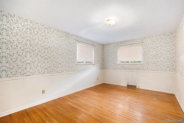 6019 Taft Ct, Arvada, CO 80004 - spare room featuring wallpapered walls, light wood-type flooring, and wainscoting