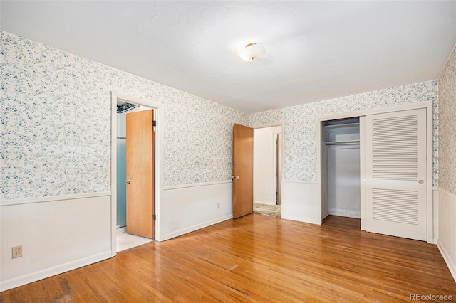 6019 Taft Ct, Arvada, CO 80004 - unfurnished bedroom with wallpapered walls, light wood finished floors, wainscoting, and a closet